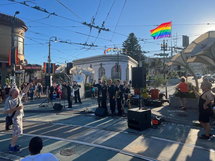 The new giant rainbow flag flies at Castro and Market streets September 29 as members of the U.S. Navy band prepared to perform in Jane Warner Plaza when they were in San Francisco for Fleet Week activities. Photo: Warner Johnson via Castro Merchants Association<br><br>