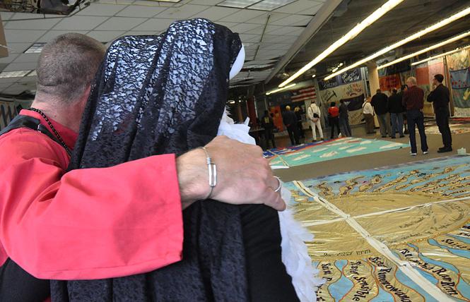 Sister Jezabelle, left, and Sister Honey, BE! look at the quilt panels dedicated to lost members of the Sisters of Perpetual Indulgence at the display of the AIDS Memorial Quilt in the Castro district that took place in 2012. Photo: Rick Gerharter