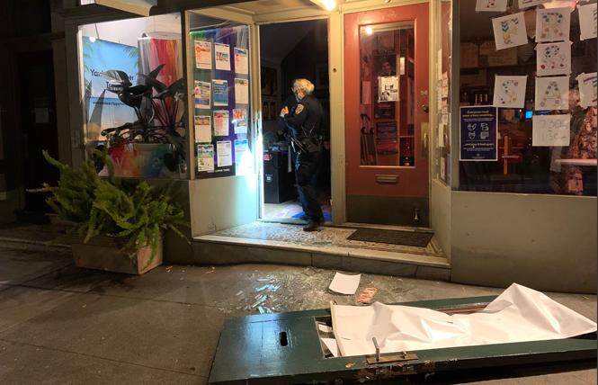 A police officer investigates an alleged break-in on the 4100 block of 19th Street early Wednesday morning. Photo: Sari Staver